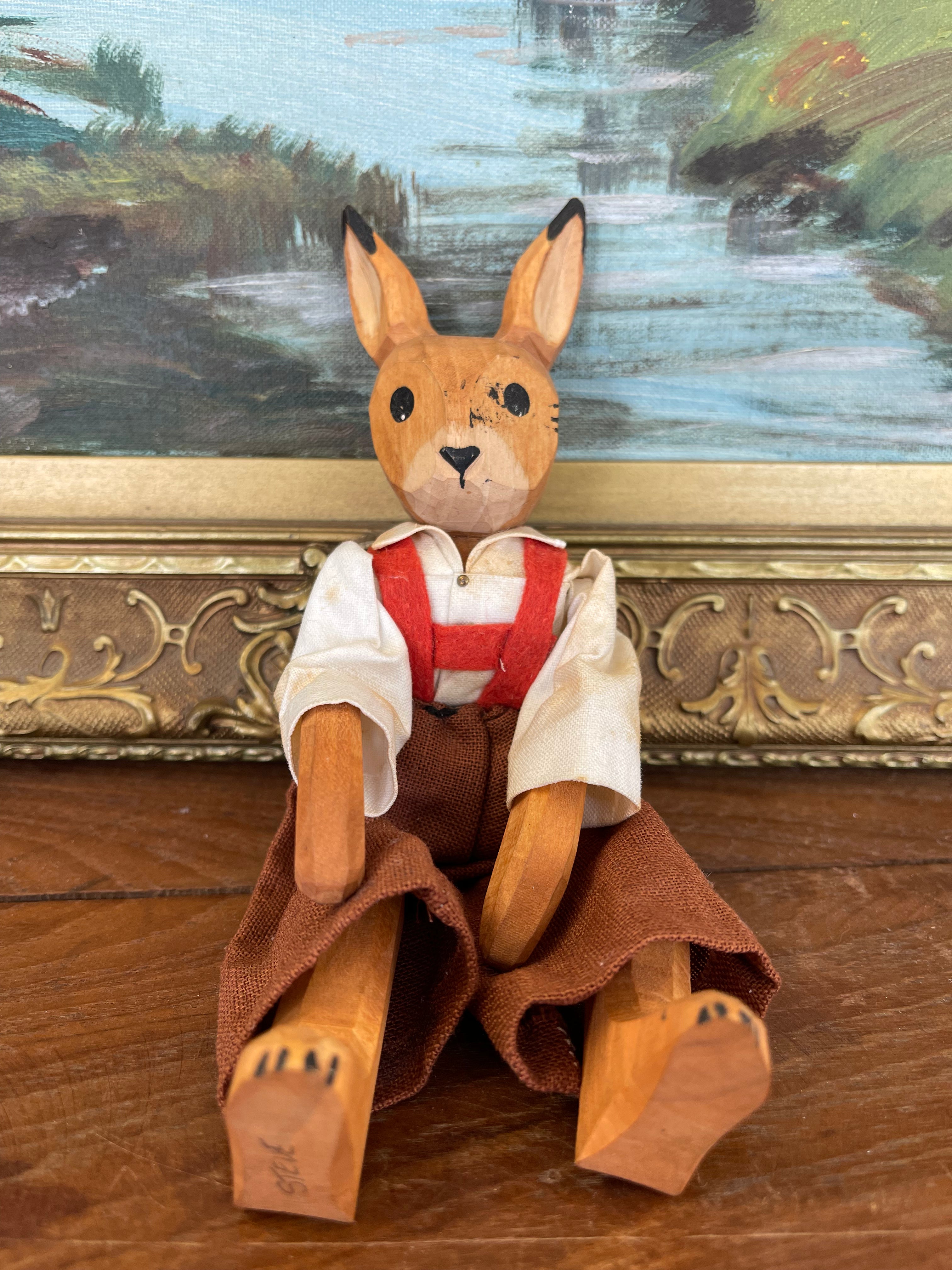 Vintage Hand-Carved Wooden Rabbit Doll with Articulated Limbs and Handmade Clothing.