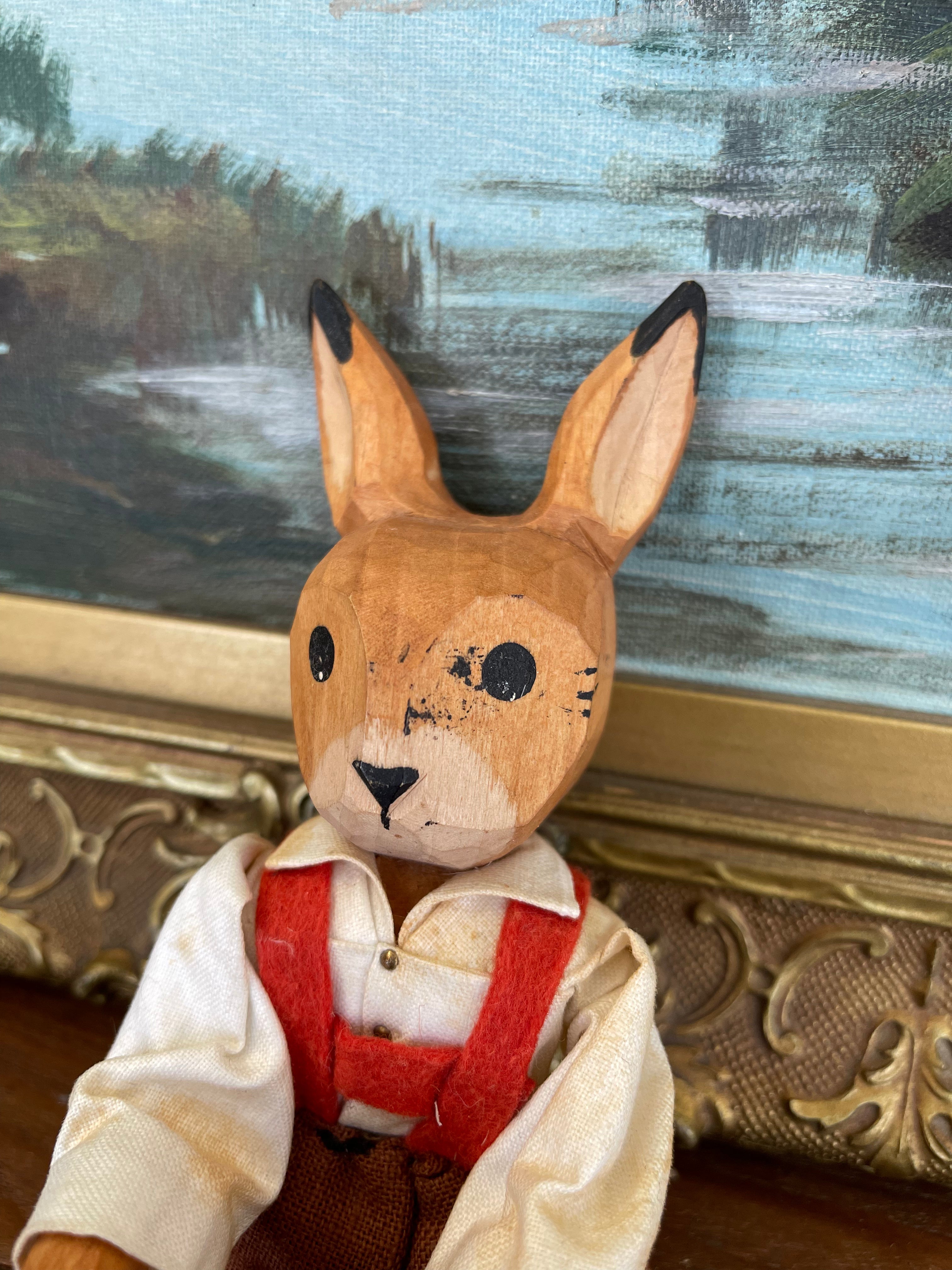 Vintage Hand-Carved Wooden Rabbit Doll with Articulated Limbs and Handmade Clothing.