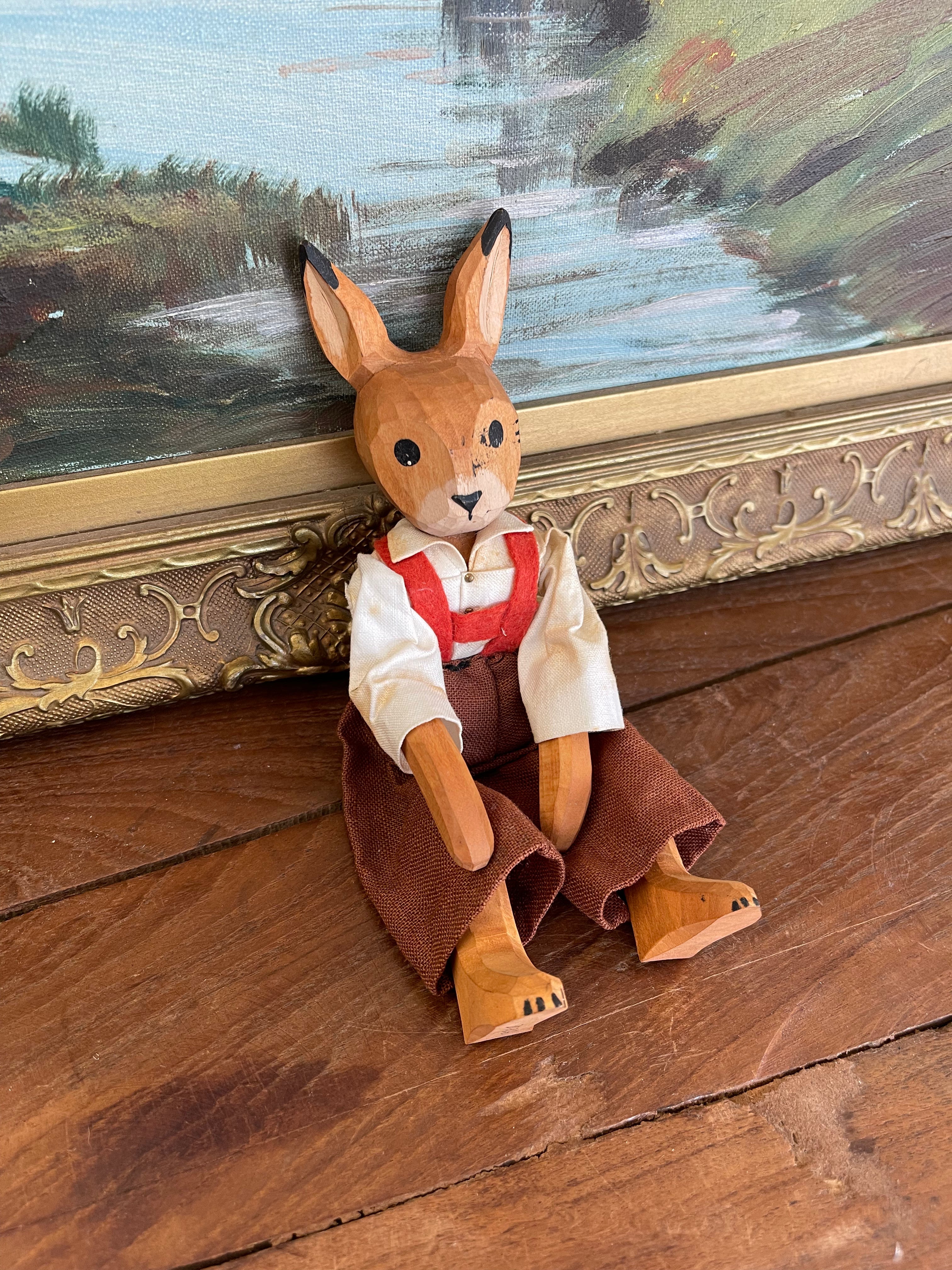 Vintage Hand-Carved Wooden Rabbit Doll with Articulated Limbs and Handmade Clothing.