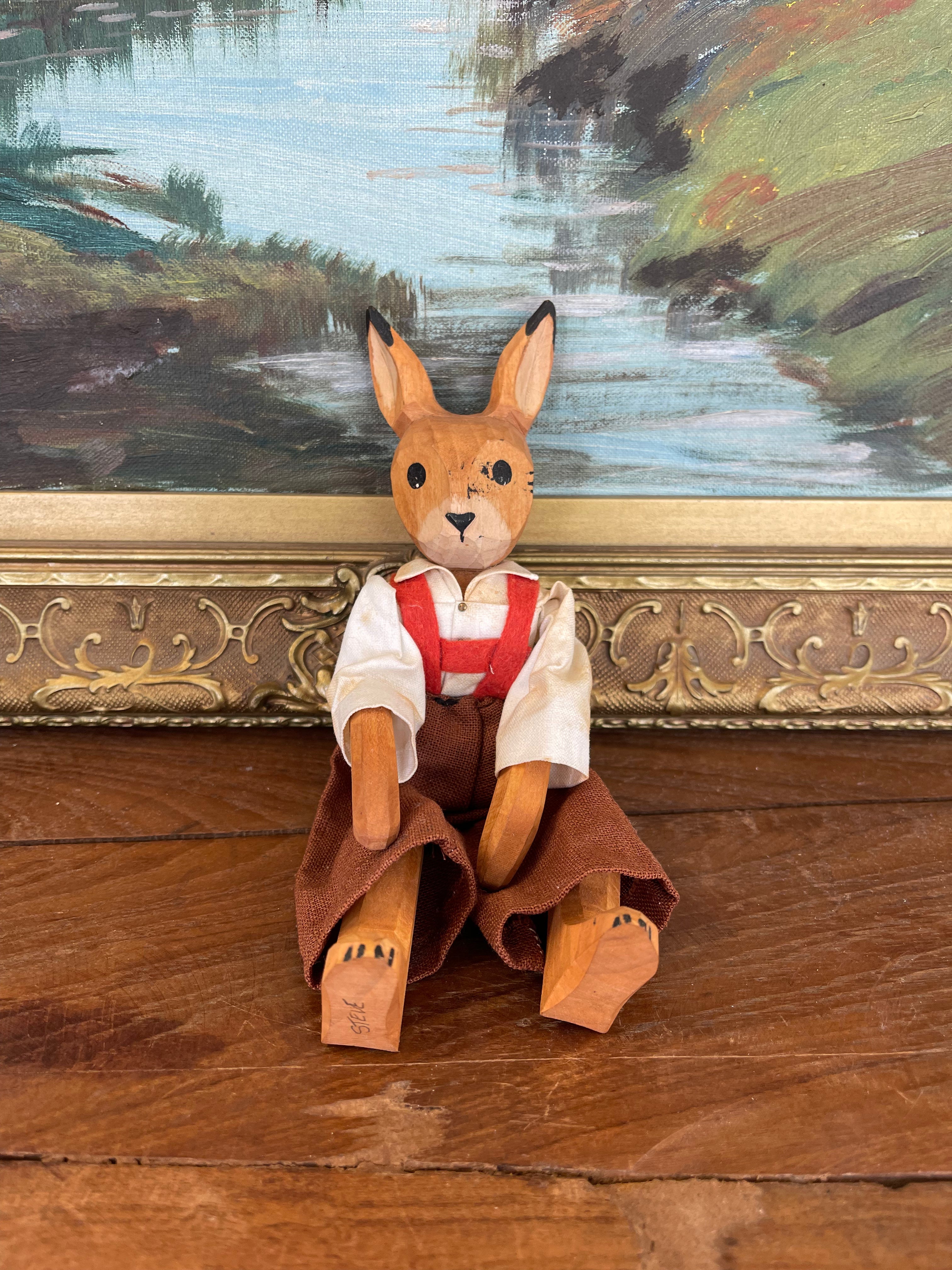 Vintage Hand-Carved Wooden Rabbit Doll with Articulated Limbs and Handmade Clothing.