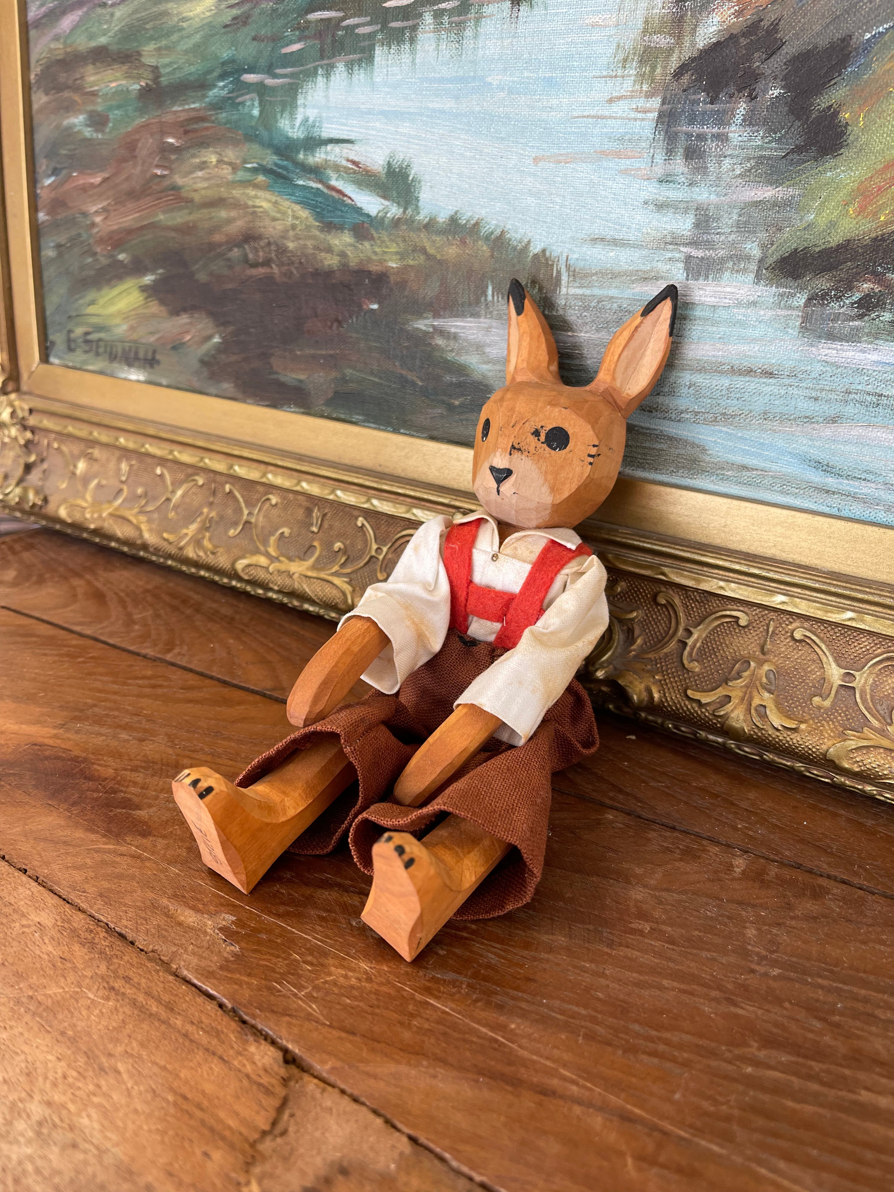 Vintage Hand-Carved Wooden Rabbit Doll with Articulated Limbs and Handmade Clothing.